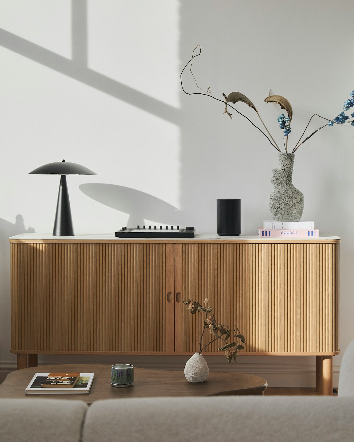 Stylish console table with modern decor against a white wall.